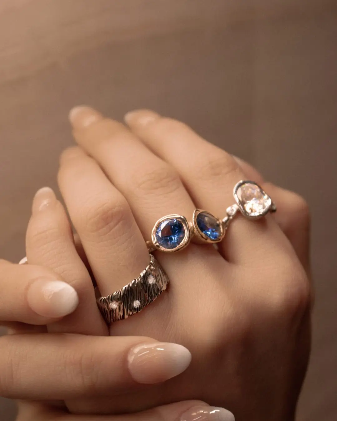 Handcrafted gold sapphire rings and a textured diamond band, custom made in our Los Angeles studio